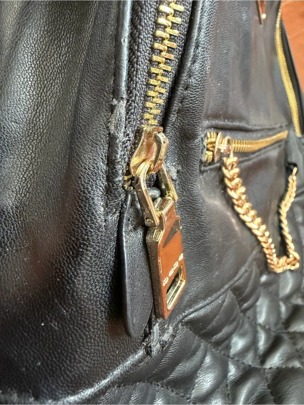 bebe Black Quilted Faux-Leather Backpack with Gold Chain & Plaque